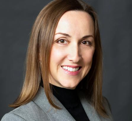 Svitlana Krasynska headshot with a dark grey background