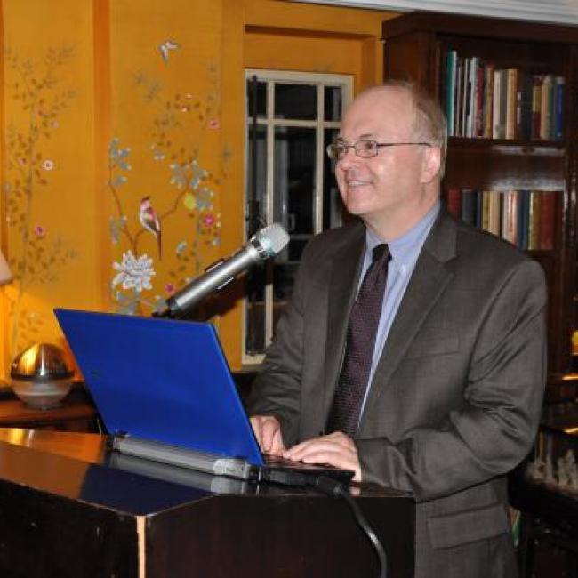 Sean Gilbert presenting at a podium