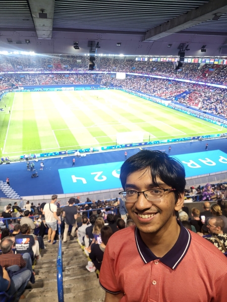 Ishan Ganguly pictured on the steps overlooking a football stadium during the Paris Olympics 2024